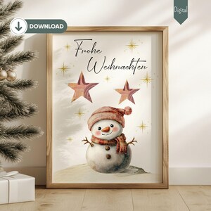 Könnte beinhalten: Ein digitaler Druck mit einem Schneemann mit roter Mütze und Schal, zwei goldenen Sternen und dem Text "Frohe Weihnachten" in einem weißen Rahmen.