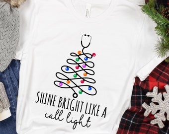 Funny Nurse Christmas Shirt: Shine Bright Call Light Sweatshirt