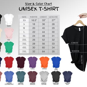May include: A black unisex t-shirt hanging on a wooden hanger, with a size and color chart. The chart lists sizes XS to 5XL, with measurements in inches for width, chest, and length. Various t-shirt colors are displayed, including black, white, and navy.