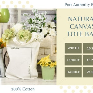 K&ouml;nnte beinhalten: Eine wei&szlig;e Canvas-Tragetasche mit dem Text "NATURAL CANVAS TOTE BAG" und den Ma&szlig;en: Breite 38,7 cm, L&auml;nge 40 cm, Griff 54,6 cm. Die Tasche ist aus 100 % Baumwolle.