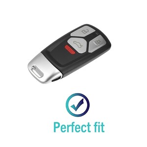 May include: A black and silver car key with four buttons. The buttons are labeled with icons for unlock, lock, trunk, and panic. The key has a silver metal key ring.