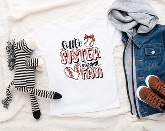 May include: White t-shirt with red and white baseball graphic and the text "little sister biggest fan".