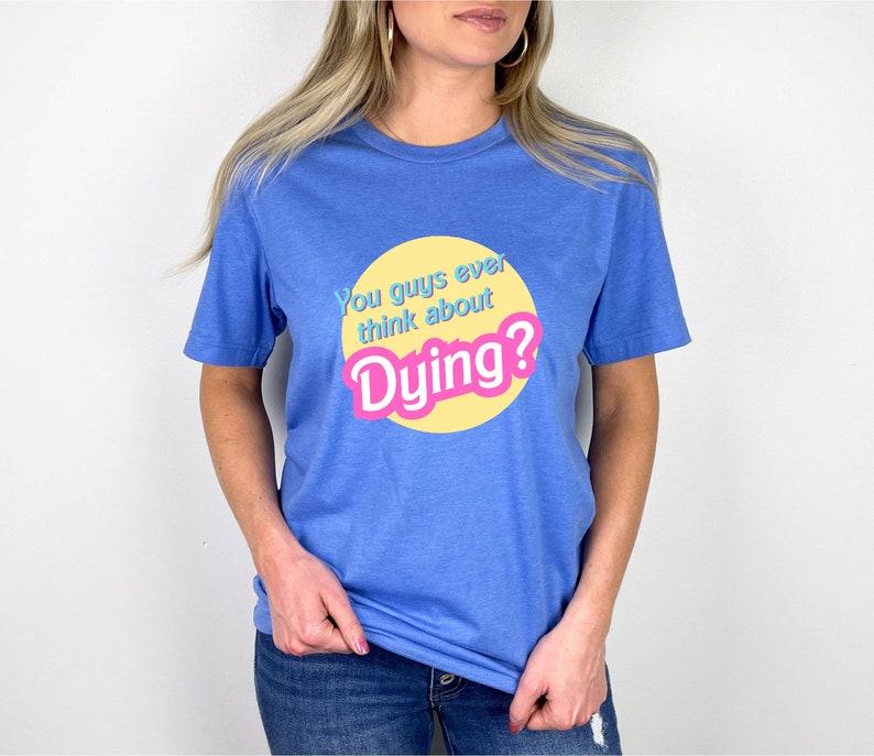 May include: A blue t-shirt with a yellow circle and the text "You guys ever think about Dying?" in pink and blue letters.