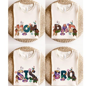 May include: Four white t-shirts with a Moana theme. The shirts feature the words "MOM", "DAD", "SIS", and "BRO" with Moana characters and tropical elements.