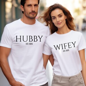 May include: A handmade wooden sign with the text "Welcome" in a playful font. The sign features a distressed white background and a dark brown frame, suitable for indoor or outdoor use.