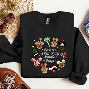 May include: Black sweatshirt with a Christmas-themed design featuring Mickey Mouse characters, candy canes, and the text "These are a few of my favorite things."