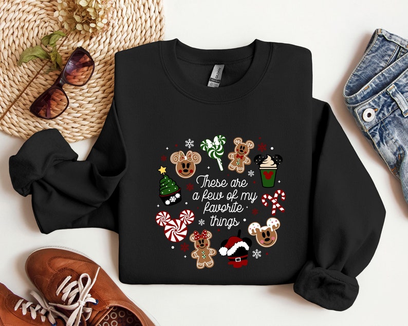 May include: Black sweatshirt with a Christmas-themed design featuring Mickey Mouse characters, candy canes, and the text "These are a few of my favorite things."