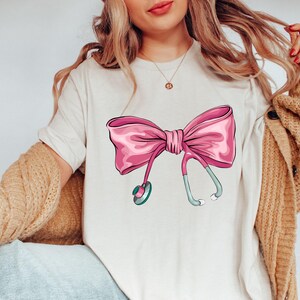 Coquette Nurse Stethoscope Bow Sweatshirt, Gift for Nurse, Bow Oversized Shirt, Nurse Appreciation, Christmas Gift for Nurse, Pink Bow Shirt