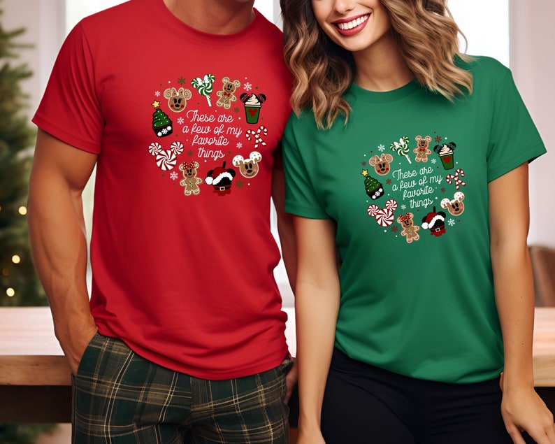 May include: Red and green t-shirts with a Christmas-themed design featuring Mickey Mouse and gingerbread characters. The text on the shirts reads "These are a few of my favorite things."