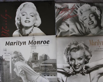 May include: Four different Marilyn Monroe calendars, each featuring a black and white photo of the actress. The calendars are from 1999 and 2003.