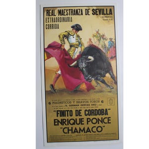 May include: A vintage poster advertising a bullfight at the Real Maestranza de Sevilla. The poster features a bullfighter in a red and gold suit, facing a black bull. The text on the poster reads "Real Maestranza de Sevilla", "Extraordinaria Corrida", "Domingo", "Tarde 5.30", "6 Magnificos y Bravos Toros 6", "D. German Gervas Diez", "Finito de Cordoba", "Enrique Ponce", and "Chamaco".
