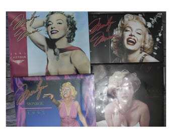 May include: Four different vintage calendars featuring Marilyn Monroe. Each calendar has a different image of Marilyn Monroe and the text "Marilyn Monroe" and the year "1995".