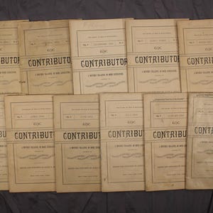 May include: A stack of vintage magazines titled "The Contributor: A Monthly Magazine of Art, Literature, and Music". The magazines are bound in brown paper with black text and are in good condition.