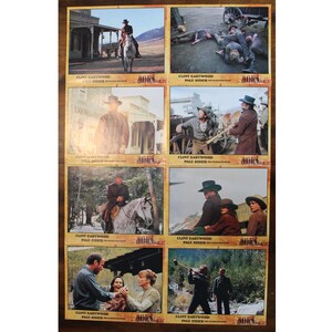 May include: A set of eight vintage movie lobby cards featuring scenes from the film "Pale Rider" starring Clint Eastwood. The cards are in good condition and show signs of age. Each card features a different scene from the film, including Clint Eastwood on horseback, a shootout, and a close-up of Eastwood's face.
