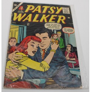 May include: A vintage comic book titled "Patsy Walker" with a cover illustration of a couple embracing. The cover features the text "Patsy Walker" in yellow and red, with additional text and a price of 10¢. The comic is encased in a plastic sleeve.