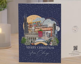 May include: A folded greeting card with a dark blue background featuring a snowy Chicago skyline illustration, the text Merry Christmas From Chicago, and a blank interior. The back includes a small logo and a QR code for scanning.
