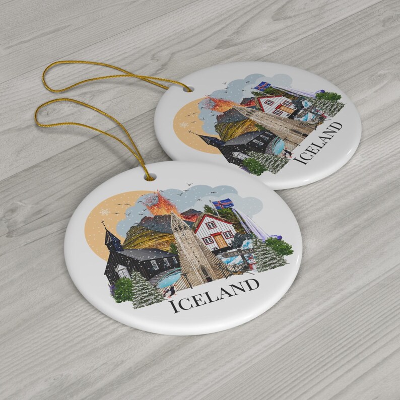 Colourful double sided Iceland ornament featuring a colourful illustration of popular Icelandic Landmarks like the Reykjavik church, waterfall, volcano, black sand beach, elephant rock, puffins and more! The text "ICELAND" is printed on under the design.