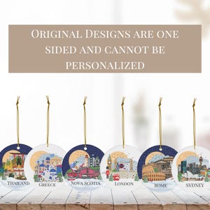 May include: Six round hanging ornaments featuring illustrations of Thailand, Greece, Nova Scotia, London, Rome, and Sydney. Each ornament has a gold string and text stating: ORIGINAL DESIGNS ARE ONE SIDED AND CANNOT BE PERSONALIZED.