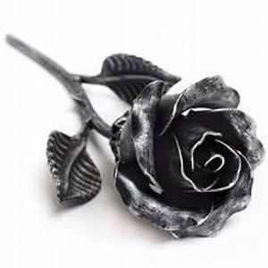 May include: A single black metal rose with leaves, handcrafted and detailed, a unique and romantic gift.