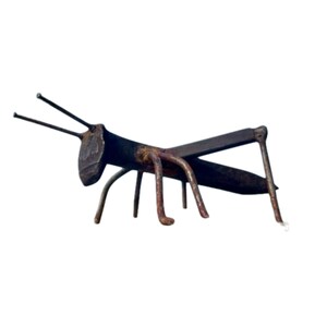 May include: A rusty metal sculpture of a grasshopper. The sculpture is made from repurposed metal and has a rustic, industrial look.