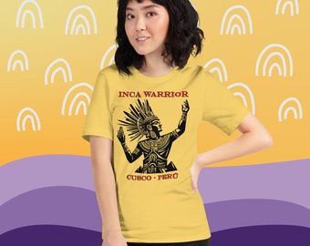 May include: A yellow t-shirt with a black graphic of an Inca warrior with the text "INCA WARRIOR" and "CUSCO - PERÚ" printed on the front.