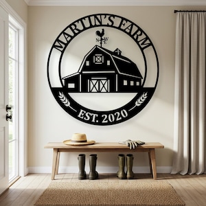 May include: Black metal farmhouse sign with the text "MARTIN'S FARM" in a circular design, featuring a barn illustration and the year "EST. 2020". The sign is mounted on a wall above a wooden bench.