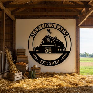 May include: Black metal farm sign with the text "Martin's Farm" in a circular design, featuring a barn silhouette and a rooster weathervane. The sign includes "EST. 2020" and wheat stalks. The sign is mounted on a white wall inside a barn.
