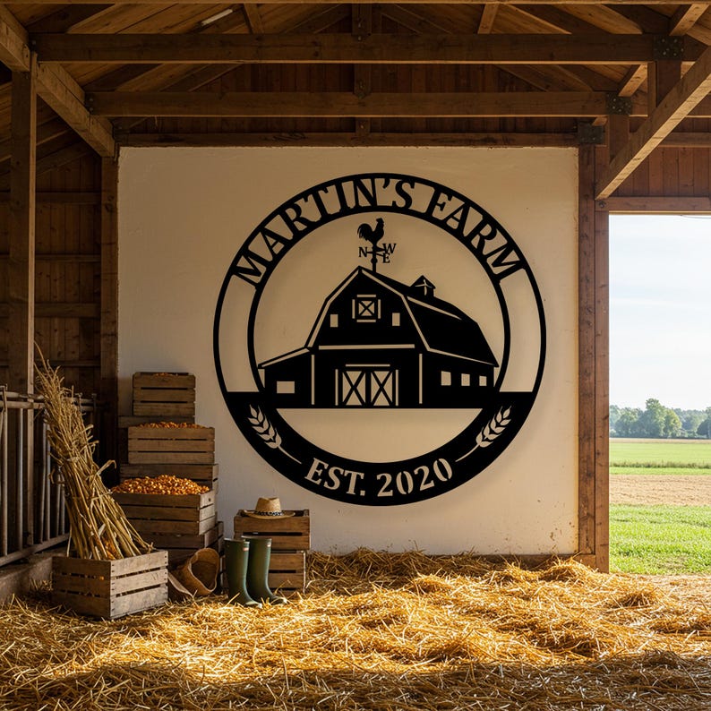 May include: Black metal farm sign with the text "Martin's Farm" in a circular design, featuring a barn silhouette and a rooster weathervane. The sign includes "EST. 2020" and wheat stalks. The sign is mounted on a white wall inside a barn.