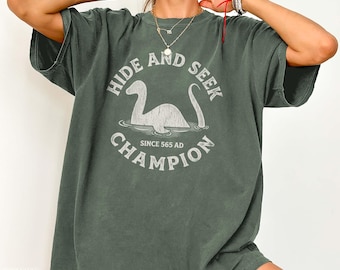 Loch Ness Monster Hide and Seek Champion Shirt Funny Nessie Cryptid Graphic Retro Travel Tee Gift for Scottish Myth Lovers Scotland Souvenir