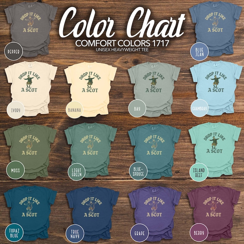 Puede incluir: Una carta de colores de camisetas unisex de peso pesado en varios colores, incluyendo azul vaquero, musgo y bayas. Cada camiseta presenta el texto "Drop It Like A Scot" con un gr&aacute;fico de un bailar&iacute;n escoc&eacute;s. La carta est&aacute; etiquetada como "Comfort Colors 1717".
