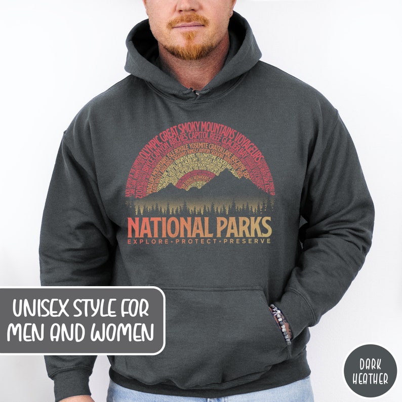 May include: Dark heather grey hooded sweatshirt with a vintage-style graphic of a mountain range with a sunset and the text "National Parks" with the words "Explore, Protect, Preserve" underneath. The graphic is surrounded by a semi-circle of text listing various national parks.