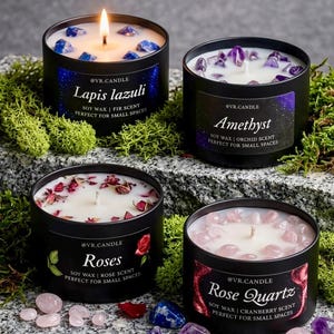 May include: Four black soy wax candles with different scents and gemstones. The candles are labeled "Lapis lazuli", "Amethyst", "Roses", and "Rose Quartz". Each candle has a different gemstone and scent. The Lapis lazuli candle is lit.
