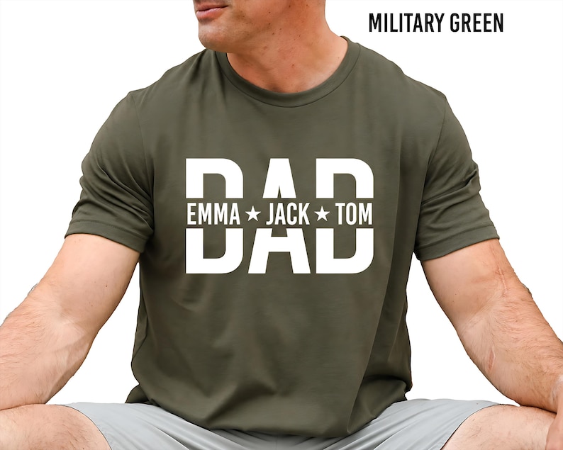 A man wearing a green t-shirt with the text "DAD" printed on it, along with the names "Emma Jack Tom".