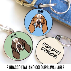 May include: Three round pet ID tags with dog illustrations. One tag has a light blue background with a dog illustration and the name "OLIVER". Another has a green background with a dog illustration and the name "ZIGGY". The third tag has the text "ESCAPE ARTIST" and a phone number.