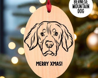 May include: A wooden Christmas bauble featuring a black and white line drawing of a Bernese Mountain Dog with the text "Merry Xmas!" and "Bernese Mountain Dog" on the bauble.