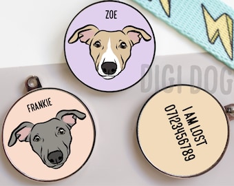 May include: Three circular pet ID tags with metal rims. Two tags feature illustrated dog faces with the names ZOE and FRANKIE printed above. The third tag displays the text I AM LOST followed by the phone number 07123456789 on a cream background.