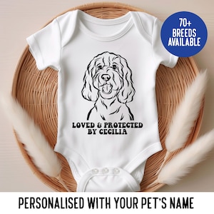 May include: White baby onesie with a black and white illustration of a dog. The text "Loved & Protected by Cecilia" is printed below the dog.  70+ breeds available.