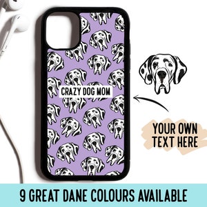 May include: A black phone case with a lavender background featuring a repeating pattern of black and white Great Dane dog faces. The case has the text "CRAZY DOG MOM" and the option to add your own text. The image also states "9 GREAT DANE COLOURS AVAILABLE".