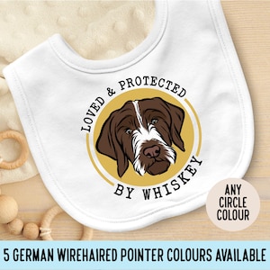 May include: White baby bib with a yellow circle and a brown and white German Wirehaired Pointer dog illustration. The text "Loved & Protected by Whiskey" is inside the circle. The text "Any Circle Colour" is in a white box with a yellow border.