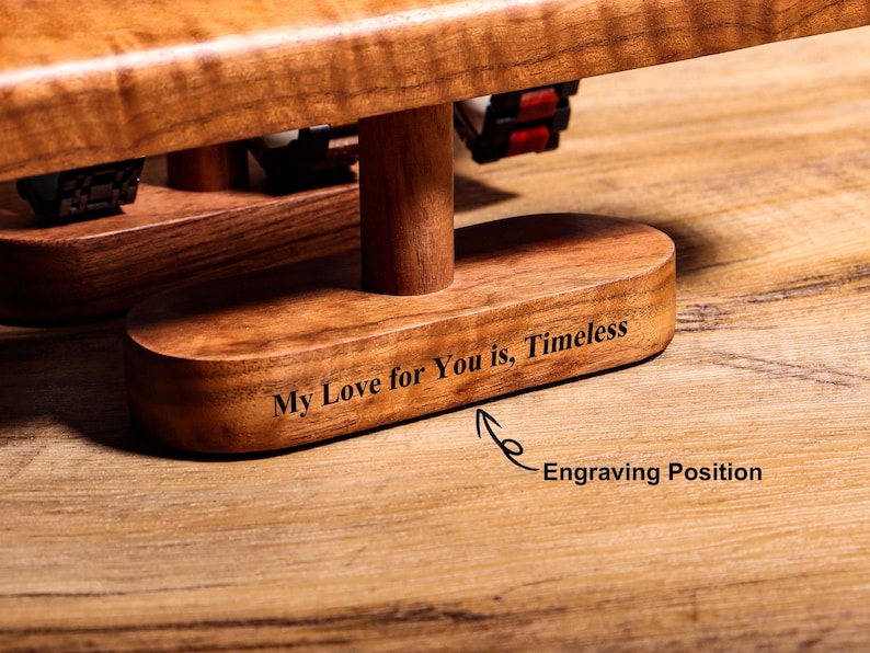 May include: A wooden watch stand with a base that is engraved with the text "My Love for You is, Timeless".