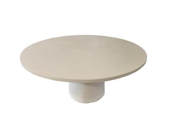 May include: A round, white, pedestal table with a smooth, flat top.