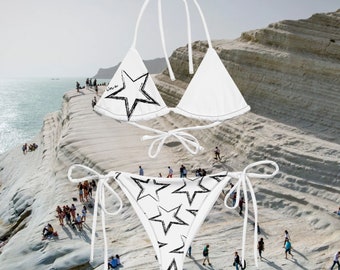 May include: White bikini with black star print. The top is a triangle style with adjustable straps. The bottom is a cheeky style with adjustable ties on the sides.
