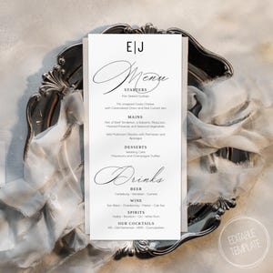 Könnte beinhalten: Eine weiße Hochzeit-Menüvorlage mit schwarzer Schrift in Kursivschrift. Das Menü umfasst Vorspeisen, Hauptgerichte, Desserts und Getränke. Der Text lautet "EJ Menu" oben auf der Seite.