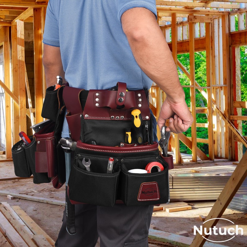 May include: A burgundy and black leather tool belt, featuring multiple pockets and pouches, filled with various hand tools. The belt has a riveted design and a leather loop. The brand name "Nutuch" is visible on the front.