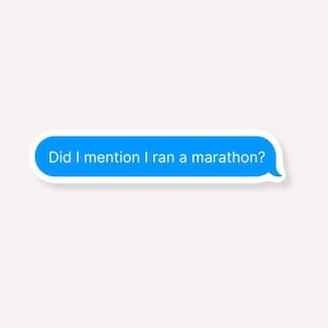 May include: A blue text bubble sticker with the text "Did I mention I ran a marathon?" in white. The sticker has a white border and is set against a light beige background.