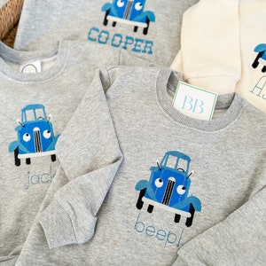Sudadera infantil con camión azul