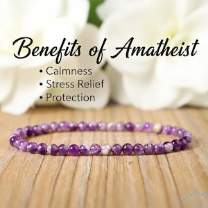 May include: A delicate amethyst bead bracelet. The bracelet is composed of small, round, purple beads with white accents. The image includes text that reads "Benefits of Amathiest: Calmness, Stress Relief, Protection."