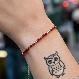 May include: A set of three ceramic mugs with a speckled, matte finish. The mugs are in shades of cream, light gray, and dark gray. Each mug has a simple, minimalist design and a rounded handle.