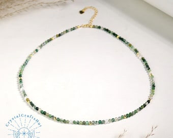 May include: A delicate green and white agate beaded necklace with a gold clasp. The necklace is made of small, round beads and is approximately 18 inches long.