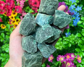 May include: A collection of green aventurine crystal roughs, with a variety of shapes and sizes. The crystals have a deep green color with flecks of gold.